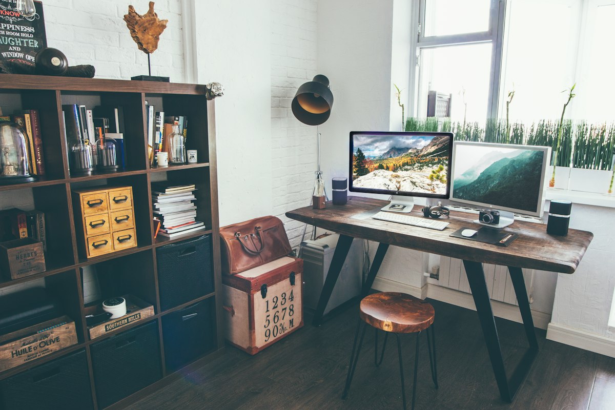 Home office with optimal monitor positioning and natural light from window