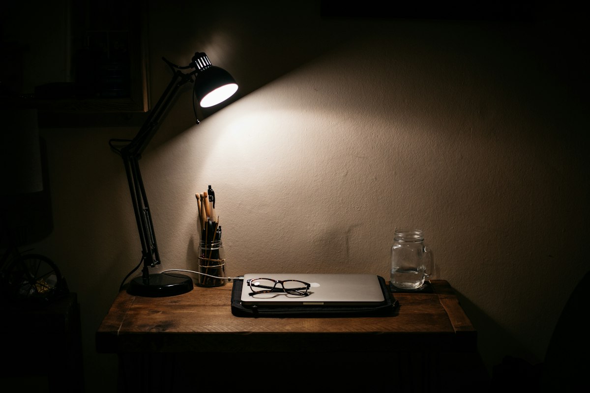 Corporate office workspace with layered lighting system and organized storage solutions