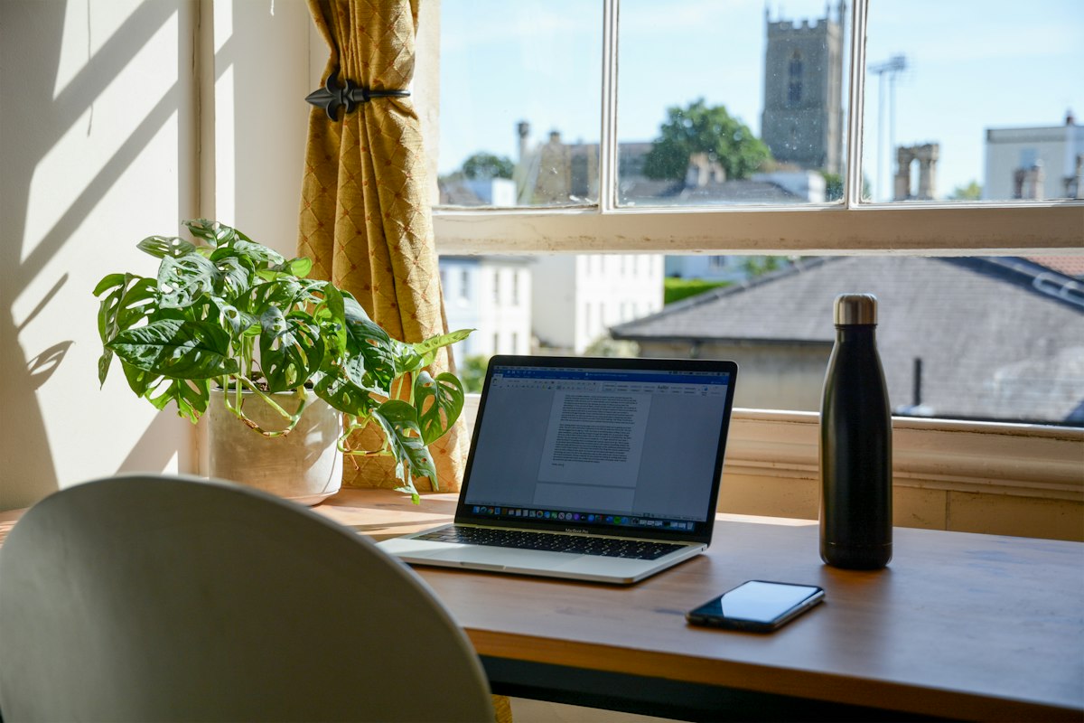 Minimalist desk with anti-glare screen protector and organized filing system